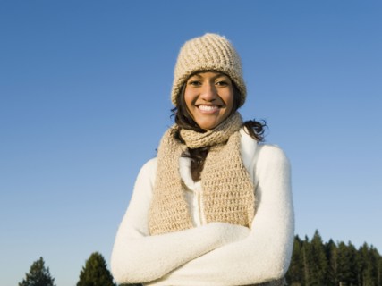 Portrait of mixed race woman smiling with arms crossed