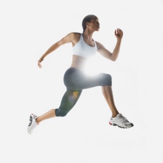 Mixed race woman jumping in mid-air