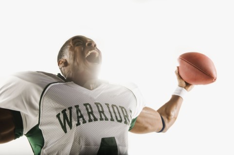 African football player holding football and celebrating