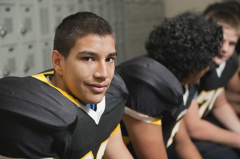 Football players dressing in locker room