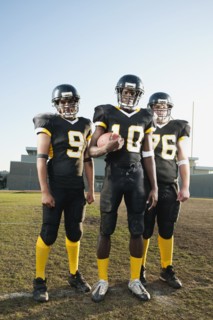 Football players standing on football field
