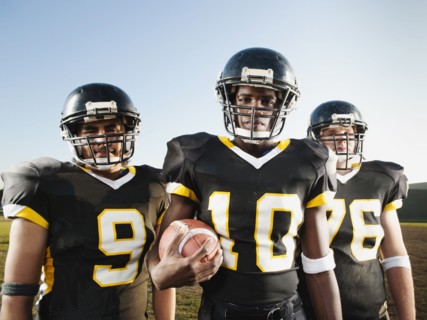 Football players standing on football field