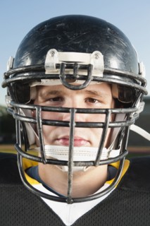 Serious Caucasian football player in helmet