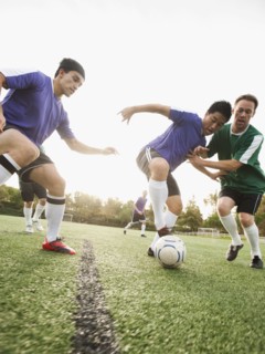 Men playing soccer on soccer field