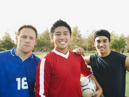 Smiling soccer players with ball