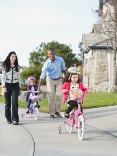 Parents watching children ride bicycles