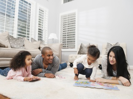 Family relaxing on living room floor