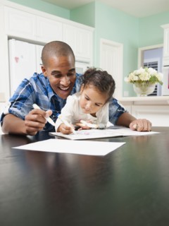 Father watching his daughter drawing