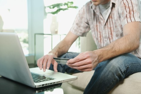 Caucasian man shopping online with credit card