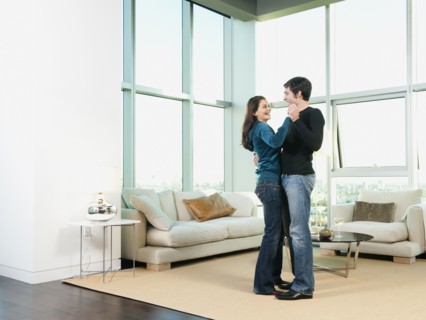Couple dancing together in living room