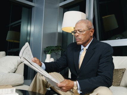 Black businessmen reading newspaper