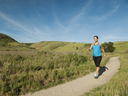 Pregnant Hispanic woman running in remote area