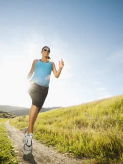 Pregnant Hispanic woman running in remote area