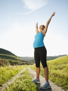 Pregnant Hispanic woman exercising in remote area