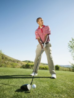 Black golfer preparing to swing golf club