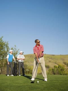 Men playing golf together on golf course