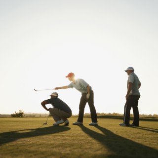 Men playing golf together on golf course
