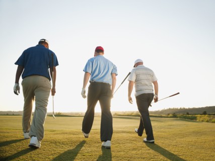 Golfers walking together on golf course
