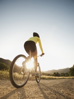 Mixed race woman riding on mountain bike