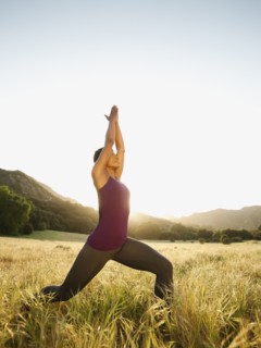 Mixed race woman practicing yoga in remote area