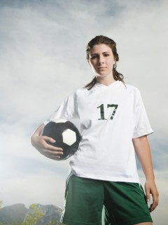 Caucasian soccer player holding ball
