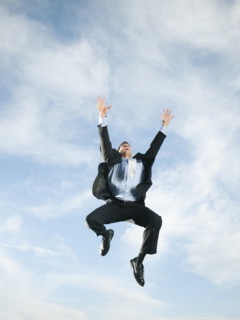 Caucasian businessman jumping in air