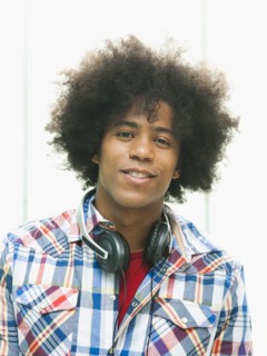 Black man with headphones around neck
