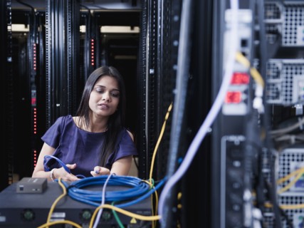Indian businesswoman working in server room