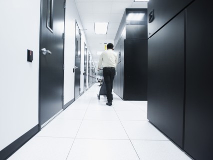 Asian businessman walking in server room