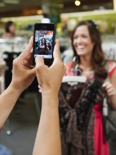 Friends shopping in clothing in store and taking pictures