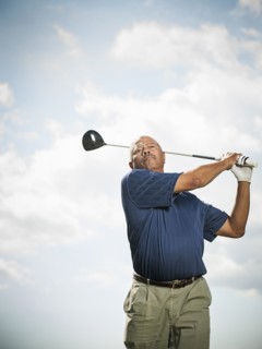 Black man playing golf