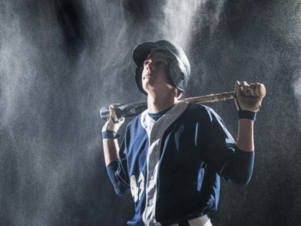 Caucasian baseball player standing in rain