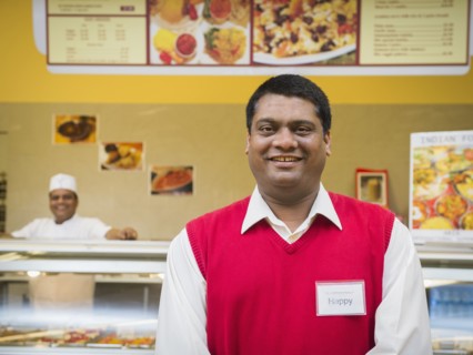Businessman smiling by restaurant counter