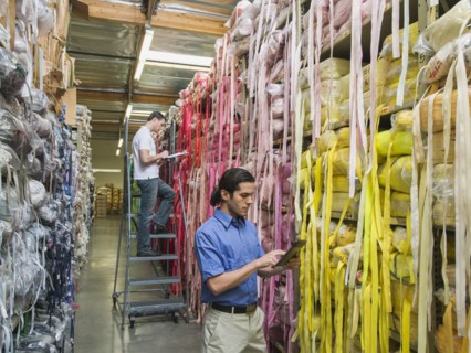 Workers examining fabric in textile factory