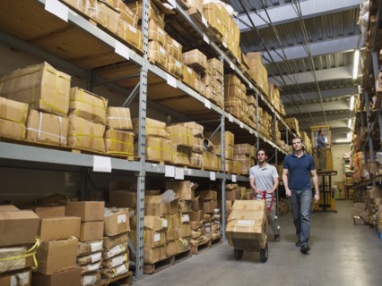 Workers carting boxes in textile factory