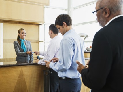 Business people in line at airport front desk