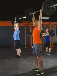 People lifting weights in gym