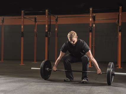 Caucasian man lifting weights in gym