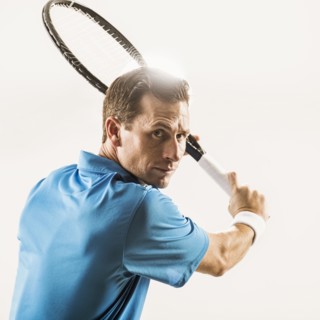 Caucasian man playing tennis