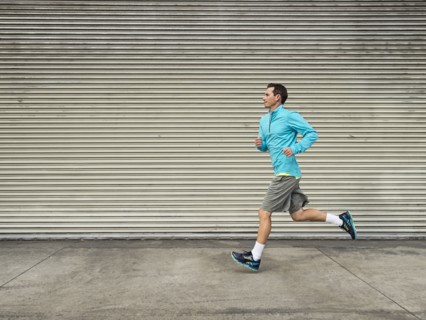 Caucasian man running on city street