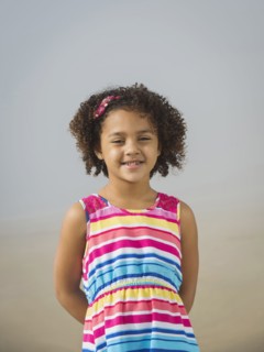 Black girl smiling on beach