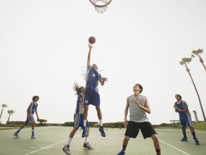 Basketball teams playing on court