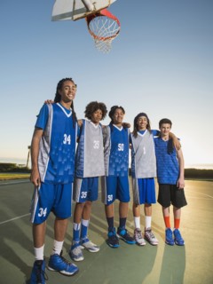 Basketball team posing on court