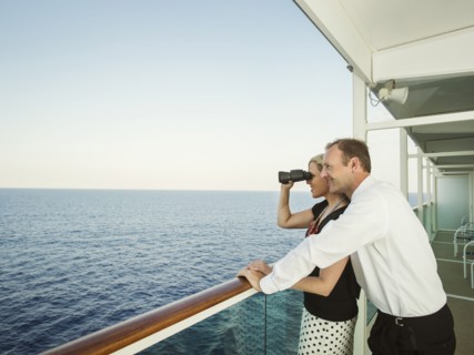 Caucasian couple admiring view from boat deck