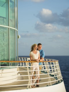 Caucasian couple admiring view from boat deck