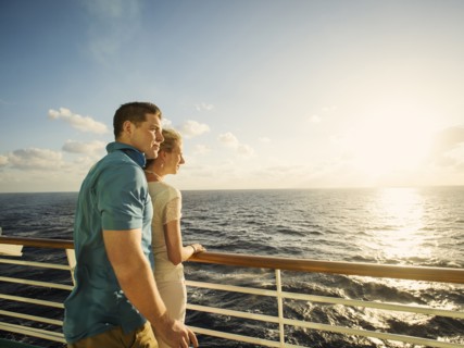 Caucasian couple admiring view from boat deck