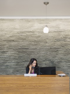 Caucasian receptionist working at office front desk