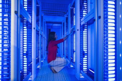Caucasian businesswoman working in server room
