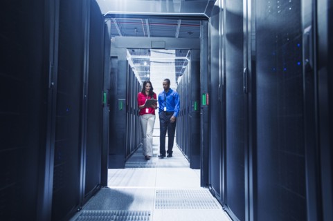 Business people talking in server room
