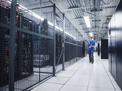 Caucasian technician using digital tablet in server room
